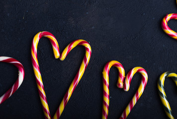 New Year and Christmas background. Christmas candy cane gingerbread on black background. New Year and Christmas composition, free space for text, New year and Christmas still life