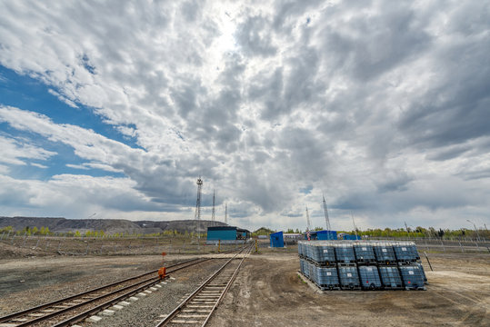 The territory of a small industrial warehouse. The warehouse is surrounded by lightning protection masts.