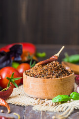 Heaps of various ground spices on wooden background. Georgian spices, Indian spices, Arabian spices. Spice variety. Herbs and spices