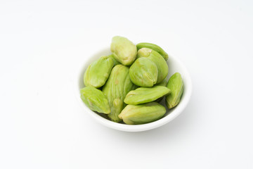 Raw Organic Orange Baby Carrots on black bowl, isolated white background