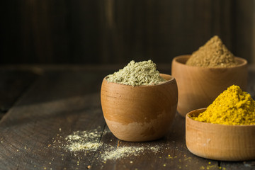 Heaps of various ground spices on wooden background. Georgian spices, Indian spices, Arabian spices. Spice variety. Herbs and spices