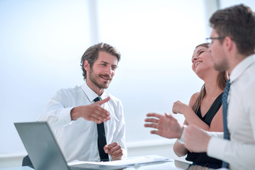 employees shaking hands at a business meeting
