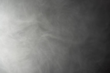 Thick white smoke on a black background - abstract background