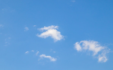 White clouds on a blue sky as a background for design