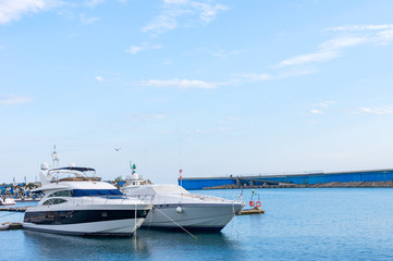 two luxury yachts parked at dock