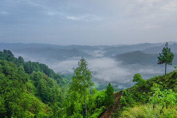 Beautiful sunrise and colorful sky over the hills. Buluh Payung Hill, Kebumen, Central Java, Indonesia