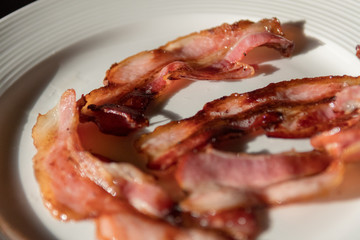 Isolated close up plate of delicious fried bacon