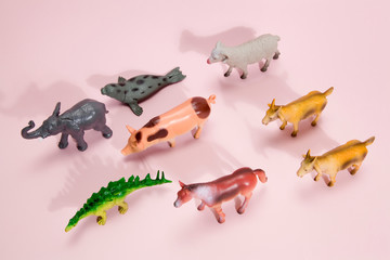 animals plastic figurine pink background