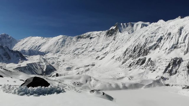 fly over a tent on a ridge in the snow, above Tilicho facing the Annapurna in Nepal
