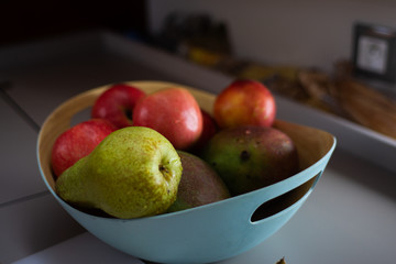 Cooking fruit salad, female hand slices fruits, closeup