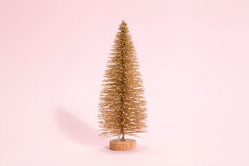 golden christmas tree pink background