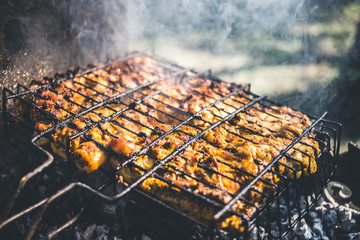 Grilled marinated chicken on a metal grid