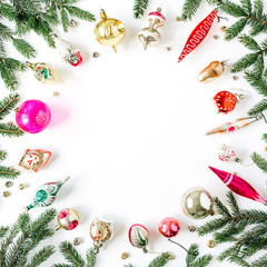 Christmas / New Year holiday composition. Mock up frame with blank copy space, fir needle branches, Christmas baubles, toys, decorations on white background. Flat lay, top view festive concept.