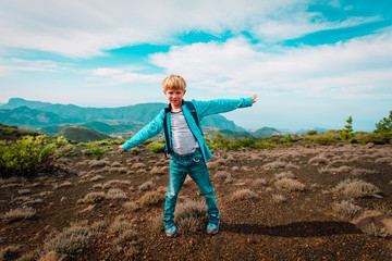 happy boy hiking in mountains, family travel