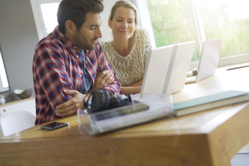 two young colleagues working in an office