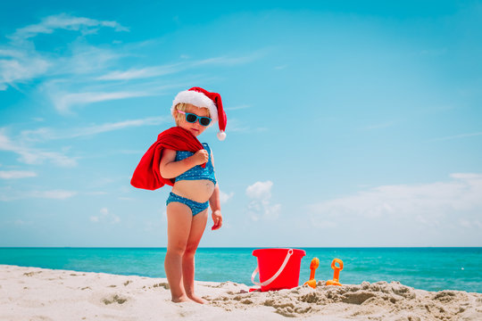 cute little girl celebrating christmas on tropical beach
