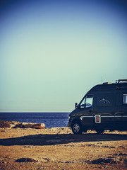 Fototapeta na wymiar Camper van on sea cliff, camping.