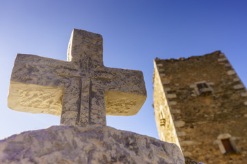 Greek stone cross and tower house, Greece