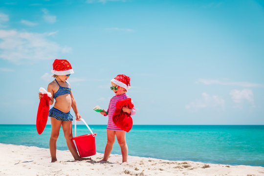cute little girls celebrating christmas on tropical beach
