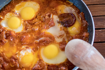 Isolated close up top view of a typical Shakshuka Israeli breakfast