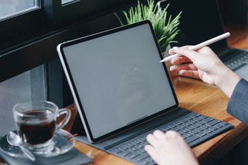 Businesswoman working with stylus and digital tablet pc at a coffee shop.