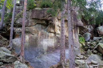Scandinavian mountain nature with stones. Rocks in the forest with moss.