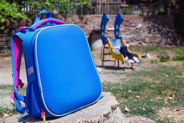 School bag and an elementary student on playground