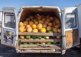 Melons and watermelons in a car market