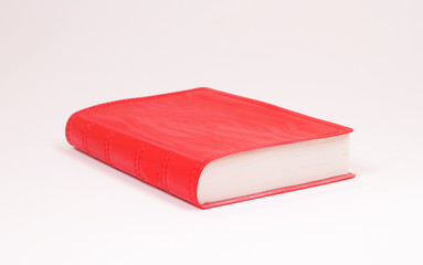 Small red book isolated on white background