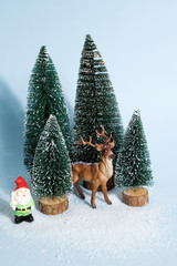 snowy forest firs gnome and reindeer blue