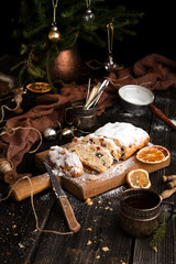 christmas dessert stollen with dried fruits, berries, nuts and powdered sugar on top