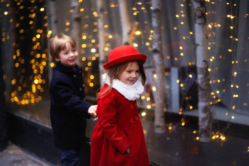 funny couple of children hug, Christmas lights