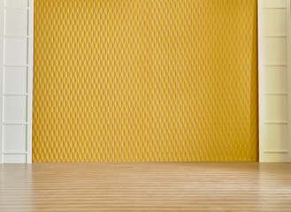 Decorative textured yellow wall background with lamp clock and bookshelf on the brown parquet, interior style.