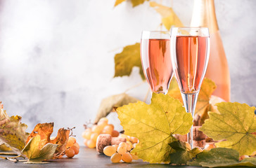 Rose pink champagne glasses and bottle, gray background, wine tasting concept, copy space © 5ph