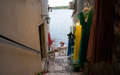 Vintage sitting place by the sea in medieval, romantic town of Rovinj in narrow stone street, Istria, Croatia
