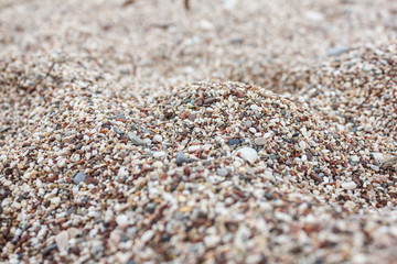Multicolored texture of beach pebbles. Natural rocks background