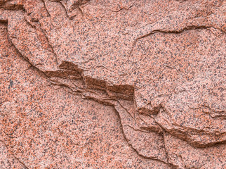 Granular granite wall as background. Selective focus.