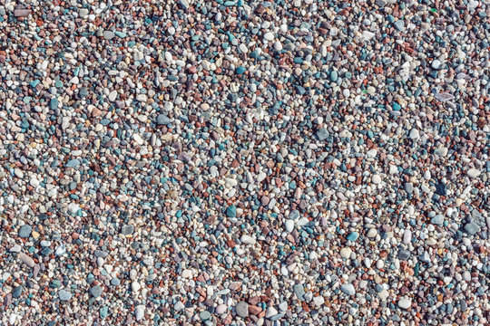 Multicolored texture of beach pebbles. Natural rocks background