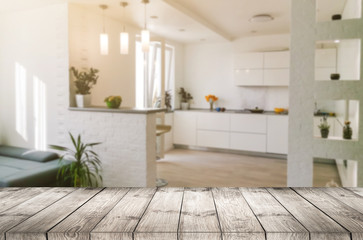 Empty textured wooden table and kitchen window shelves blurred background