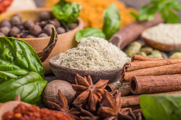 Heaps of various ground spices on wooden background. Georgian spices, Indian spices, Arabian spices. Spice variety. Herbs and spices