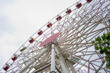 high ferris wheel and many red booths.
