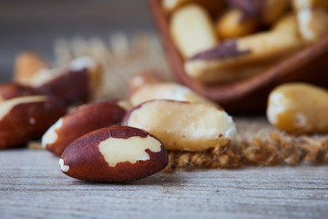 Brazil nut (Bertholletia excelsa) on rustic wooden background