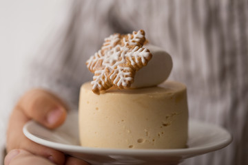 New Year and Christmas  cake or cheesecake on black background. festive mini cheesecake, with little boy hand