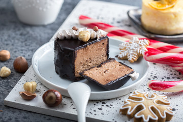 Festive Christmas Mini chocolate cakes or cheesecake  decorated with lights  on a plate