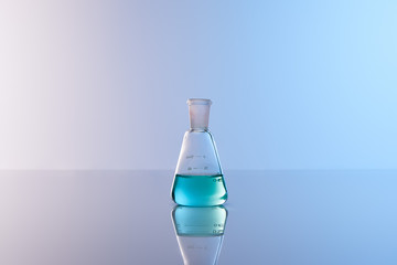 glass flask with blue colorful liquid