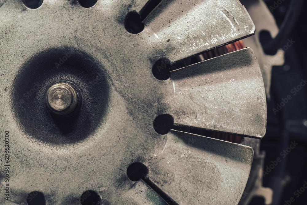 Poster close up old electric motor impeller on a dark background. macro view.
