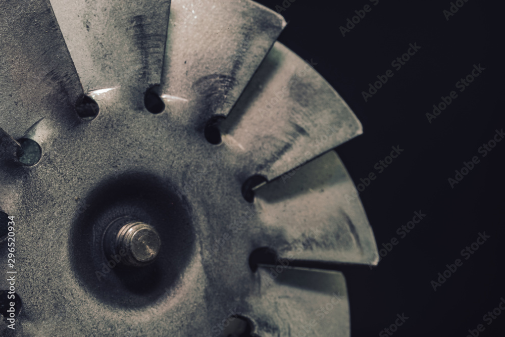 Poster close up old electric motor impeller on a dark background. macro view.