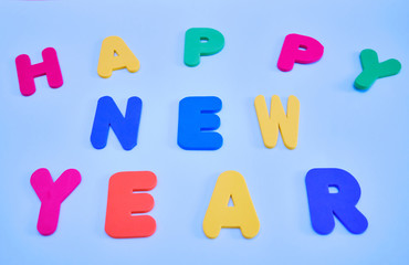Naklejka premium Text, Happy year 2020 , multicolored letters on a blue background. Happy new year