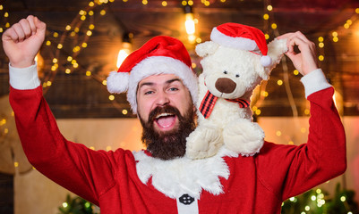 Christmas fun. new year gifts. christmas decoration. santa claus hold teddy bear. merry christmas. man santa hat. winter holidays. wait for xmas presents. happy bearded man with bear