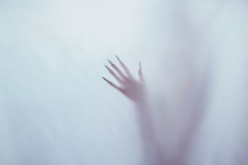 a girl with long hair in the image of a witch is trying to set herself on fire. rituals with candles for love spell and damage. expulsion of a bad spirit from the body